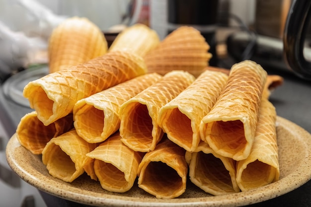 Wafer rolls on a plate. Delicious dessert. Homemade. Wooden background. Photo