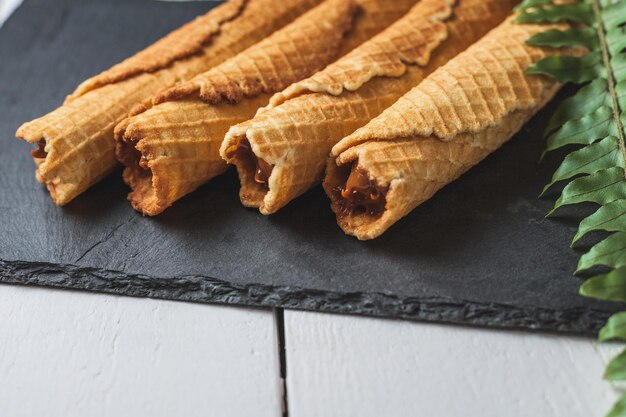 Wafer rolls with condensed milk thin and crispy waffle selective focus