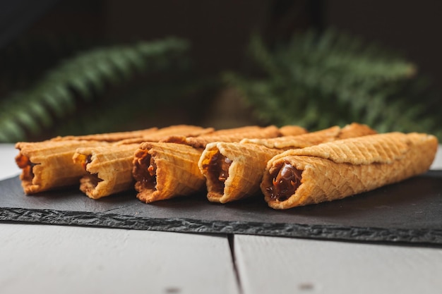 Wafer rolls with condensed milk thin and crispy waffle selective focus