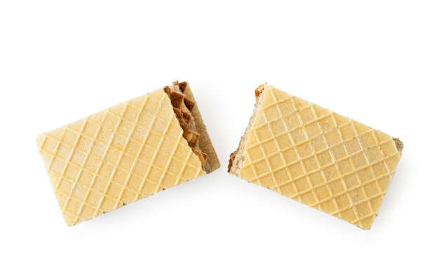 Waffle biscuits broken in half on a white background