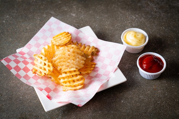 Waffle fries with ketchup and mayonnaise