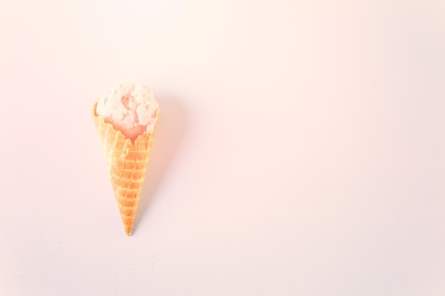 Waffle ice cream cones with scoops of ice cream on a blue background.