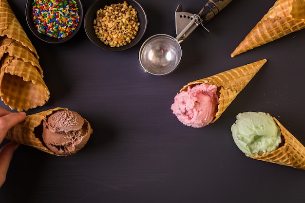 Waffle ice cream cones with scoops of ice cream.