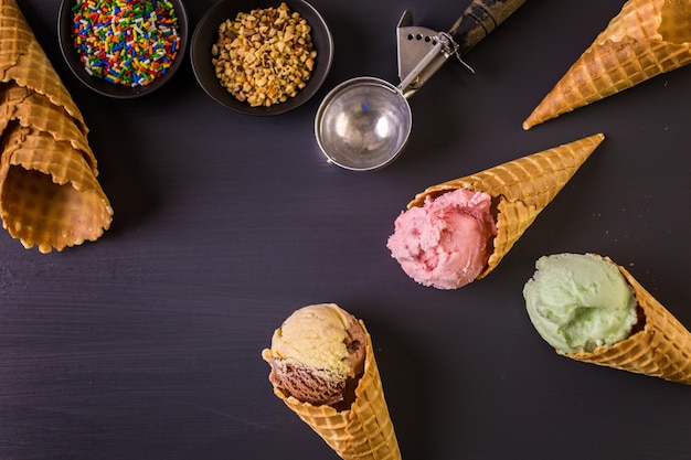 Waffle ice cream cones with scoops of ice cream.