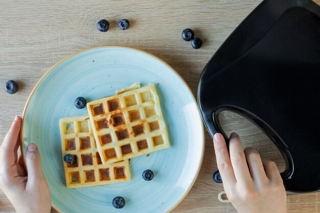 Waffles Being Baked in the Waffle Maker. Savory waffles. Breakfast concept