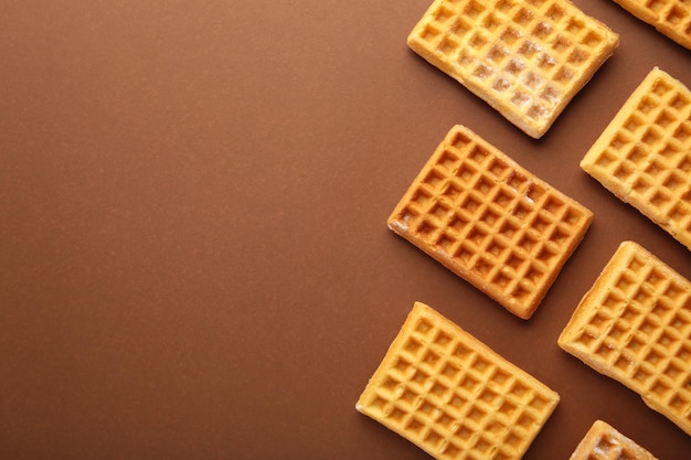 Waffles on brown background with copy space.