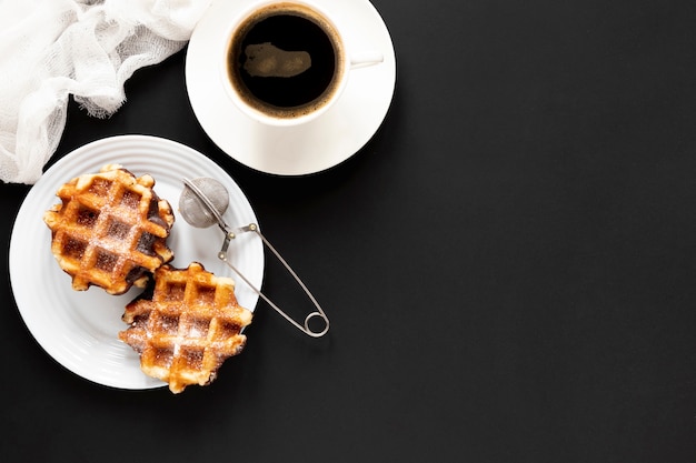 Photo waffles and coffee on black table