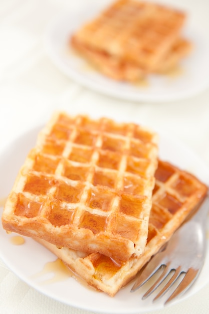 Waffles spread with honey in a plateful 