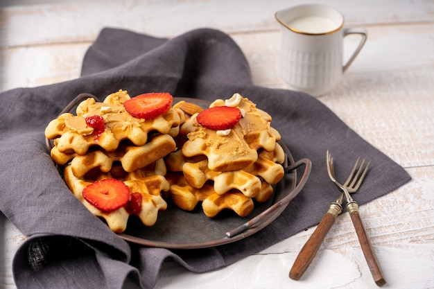 Waffles with berries and nut paste on the plate