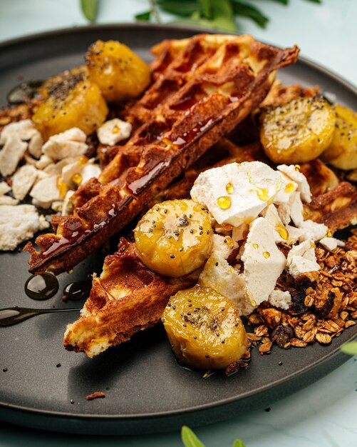 Waffles with caramelized banana and granola breakfast