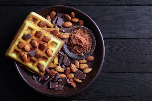 waffles with chocolate and almond nuts top view.