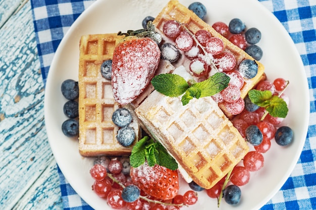 Waffles with fresh berries on the table