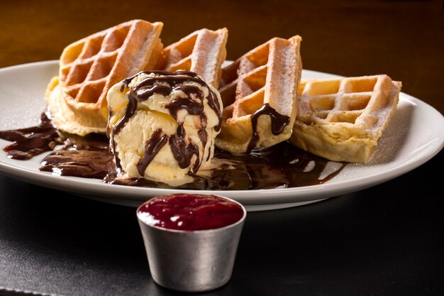 Waffles with ice cream in the plate.