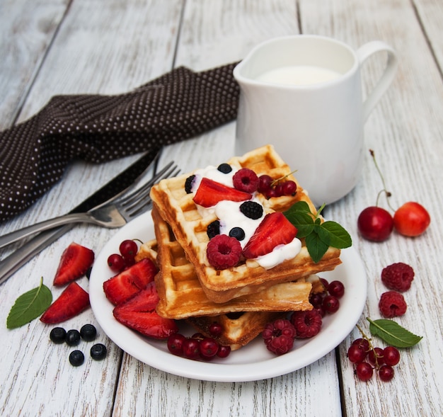 Waffles with strawberries,  blueberry and milk