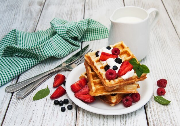 Waffles with strawberries,  blueberry and milk