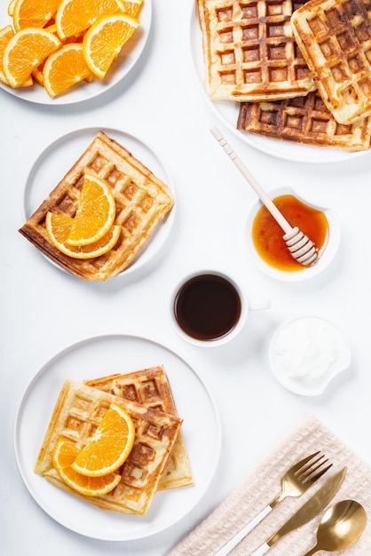 Wafflesoranges and coffee on the kitchen table