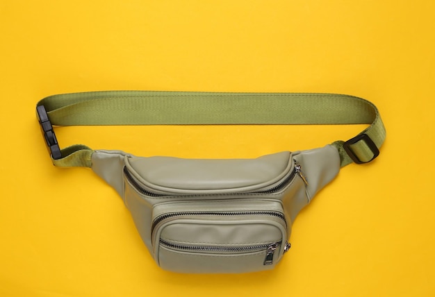 Waist banana bag on yellow background Top view