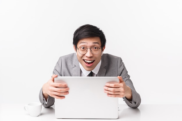 Waist-up portrait of an asian office manager in suit