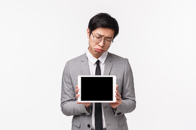 Waist-up portrait of an asian office manager in suit