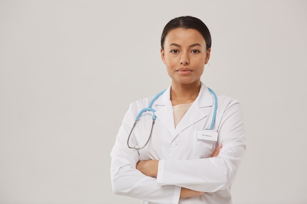 Waist up portrait of beautiful African-American nurse posing confidently