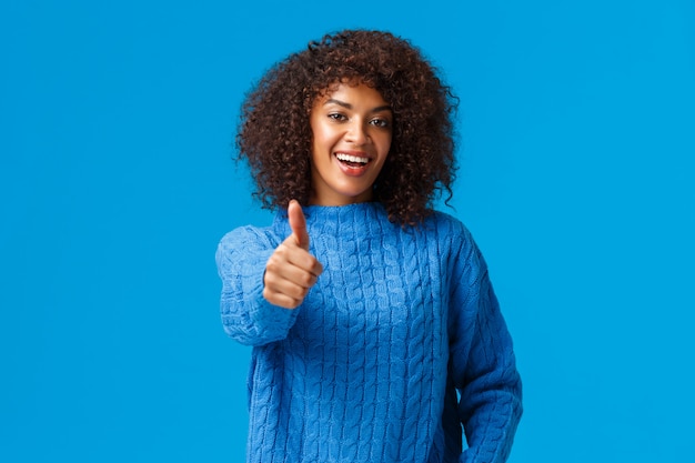 Waist-up portrait cheerful satisfied african american female with afro haircut