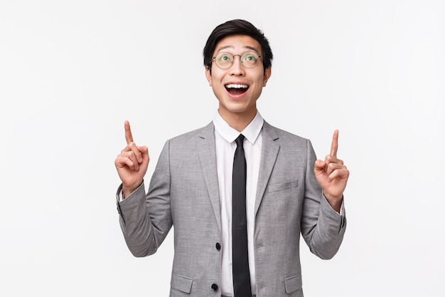 Waist-up portrait of dreamy and happy smiling asian male office manager