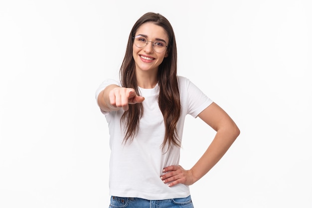 Waist-up portrait of happy smiling young woman inviting you join her team, recruit person