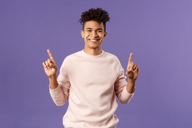 Waist-up portrait of joyful good-looking hispanic man with dreads