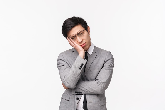 Waist-up portrait of upset unhappy young asian businessman