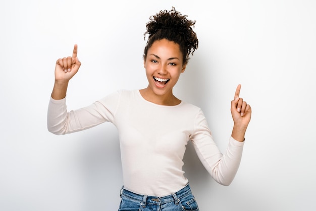 Waist up portrait of young attractive girl happy positive smile celebrate victory and rejoicing isolated over white colour background