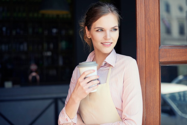 Waist up of waitress with coffee