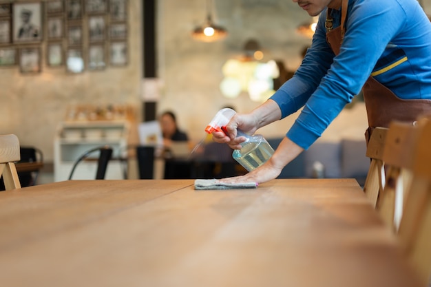 Waiter cleaning a table