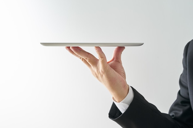 Waiter hand holding an empty digital tablet Isolated on white background concept of digital service