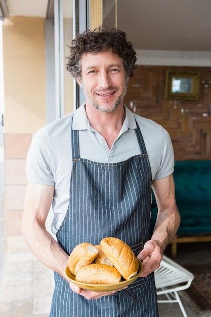 Waiter holding bowl with bread