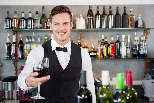 Waiter holding a glass of wine