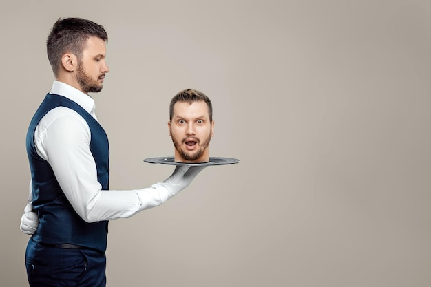 The waiter holds a man's head on a tray Metaphor bring the head head off the shoulders guilt repentance problems punishment justice Creative design magazine style