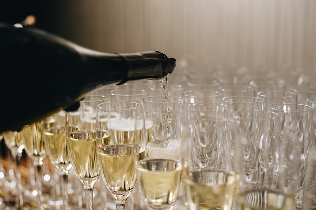 Waiter is pouring champagne into glasses, Champagne