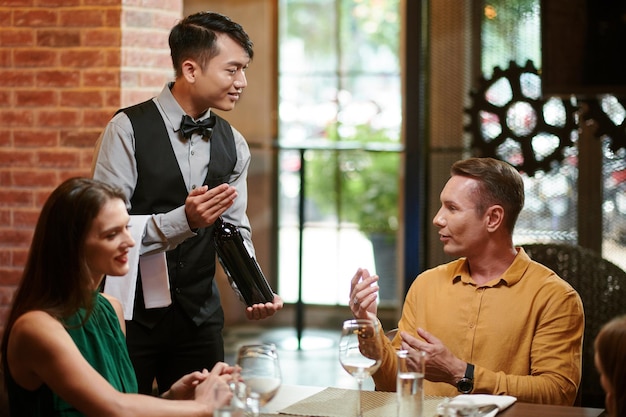 Waiter Offering Bottle of Wine