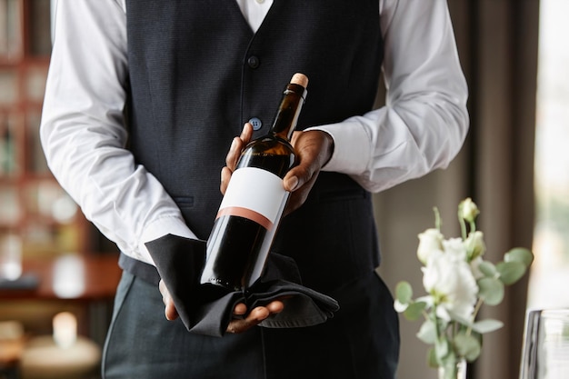 Waiter presenting bottle of red wine