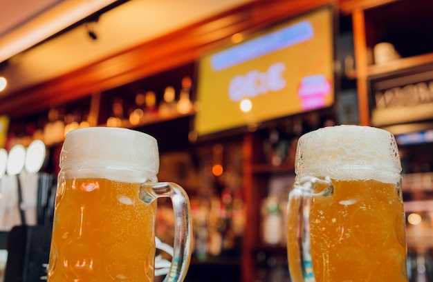 Waiter serving glasses of cold beer on the tray