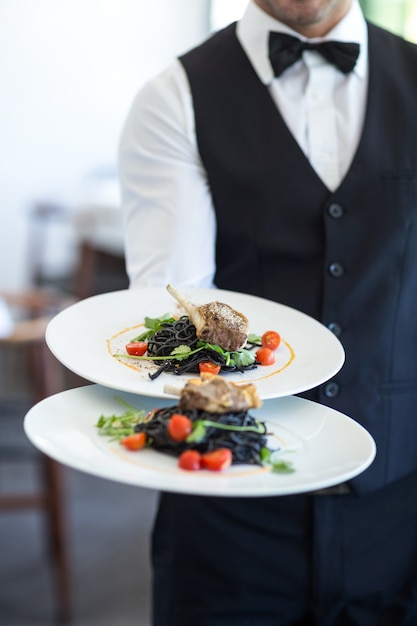 Waiter showing a dish