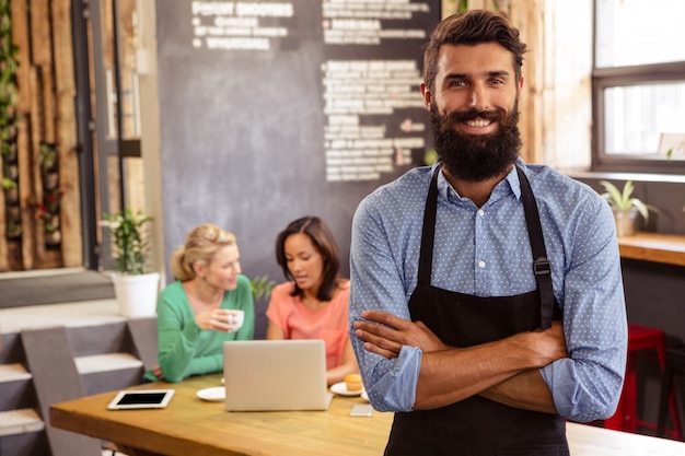 Waiter standing with arms crossed