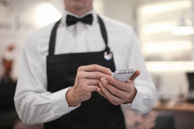 Photo waiter taking order indoors closeup