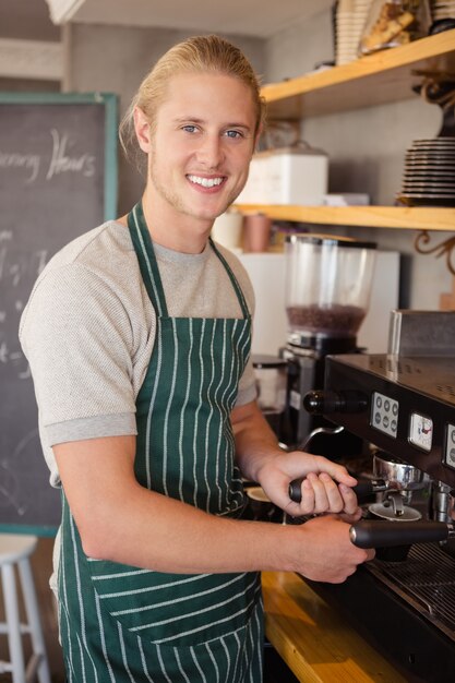 Waiter using coffee machine