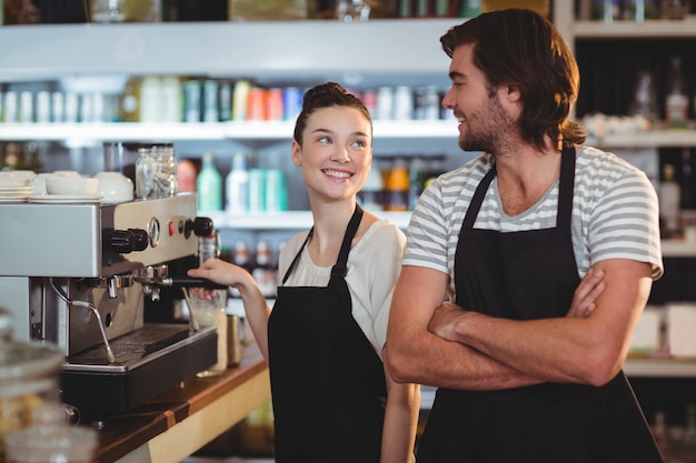 Waiter and waitress smiling at each other