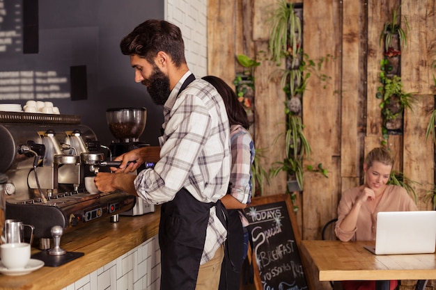 Waiter and waitresses working together in kitchen