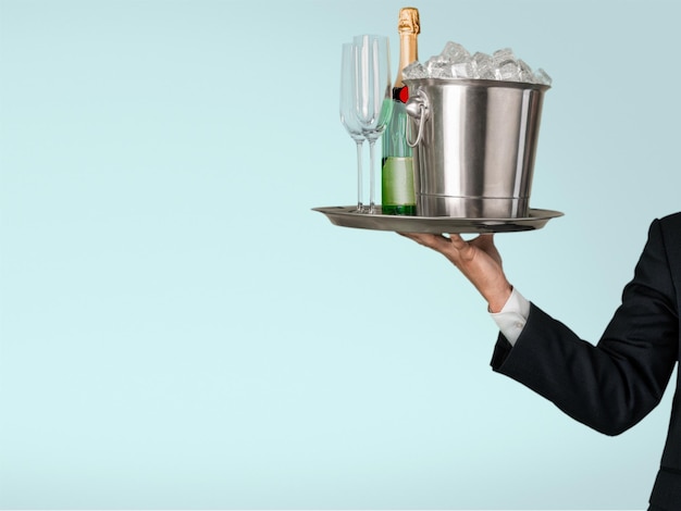 Waiter with glasses of champagne isolated on background