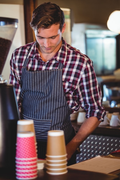 Waiter working at the till