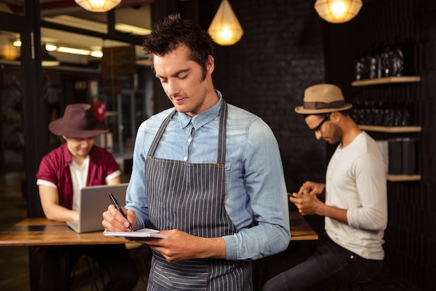 Waiter writing order