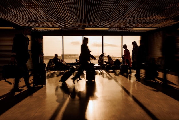 Waiting at the airport people sitting and walking with luggage motion blur